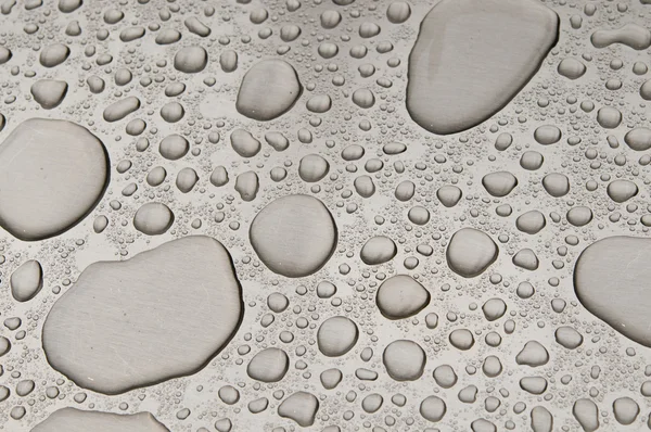 Waterdrops on brushed metal — Stock Photo, Image