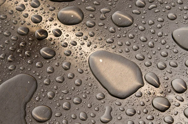 Waterdrops on brushed metal — Stock Photo, Image