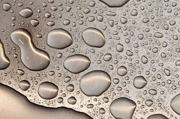 Waterdrops on brushed metal — Stock Photo, Image