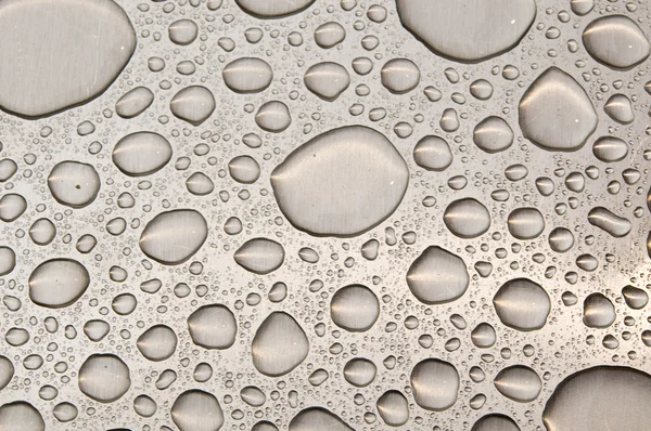 Waterdrops on brushed metal — Stock Photo, Image