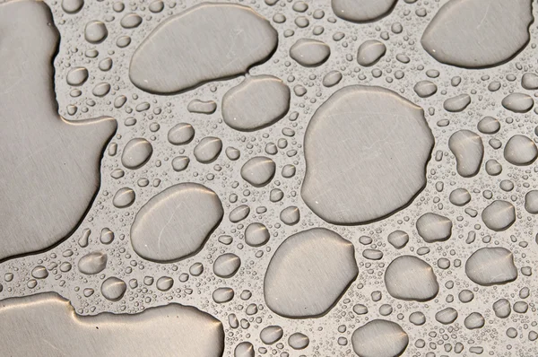 Gotas de agua sobre metal cepillado —  Fotos de Stock