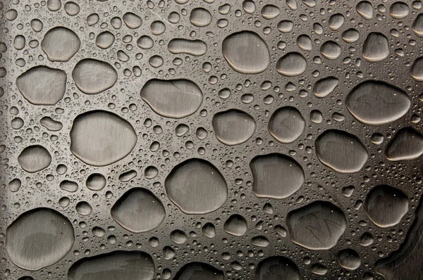 Waterdrops on brushed metal — Stock Photo, Image