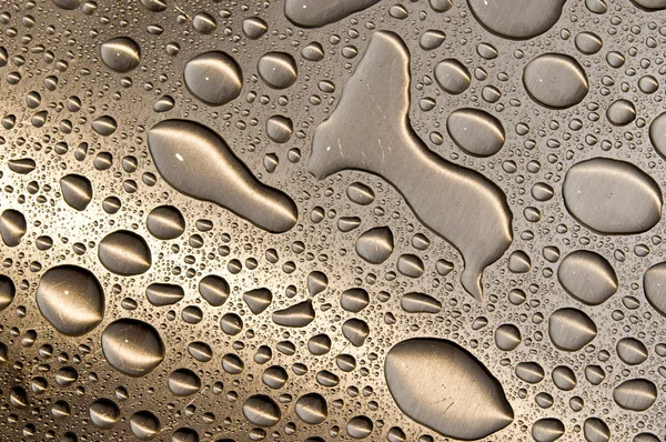 Waterdrops on brushed metal — Stock Photo, Image