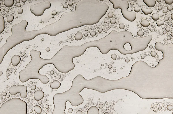 Waterdrops on brushed metal — Stock Photo, Image