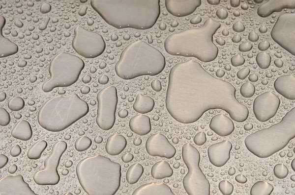 Waterdrops on brushed metal — Stock Photo, Image