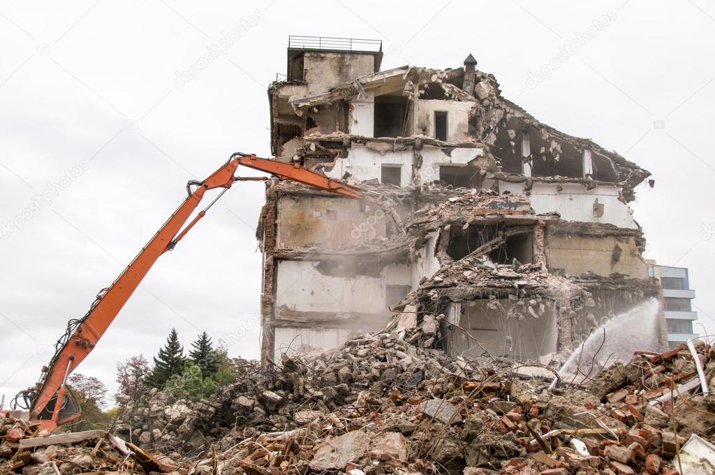 Building demolition and crashing by machinery for new construction.