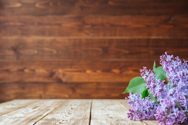 Bunch of lilac flowers on wood table