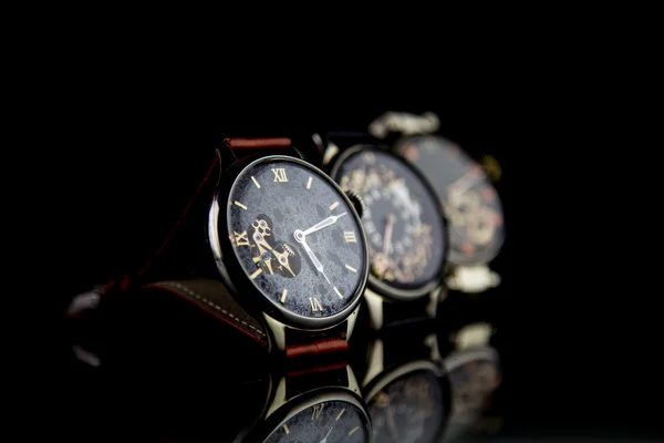 Man's watch on black background. Luxury goods.