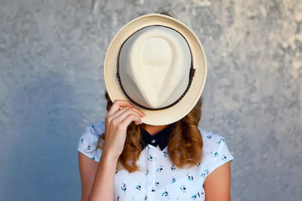 Young girl with hat. Hides her face.Depression. — Stock Photo, Image