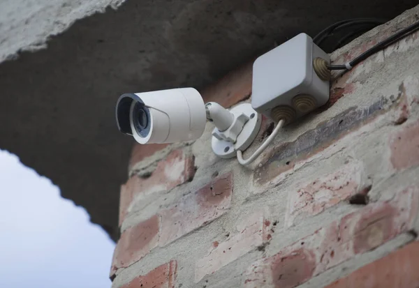 IP CCTV camera mounted on the wall of the house, home security system concept.