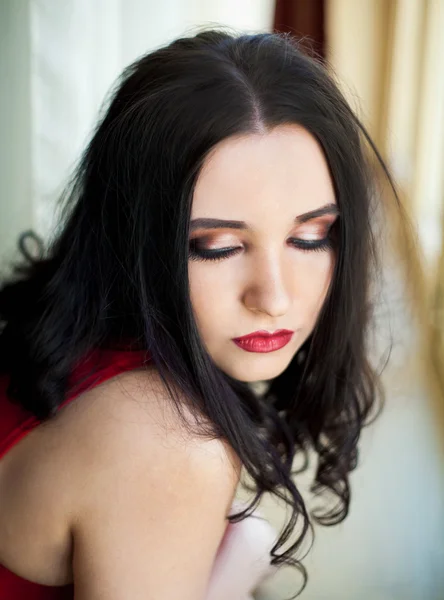 Young beautiful woman in red dress — Stock Photo, Image