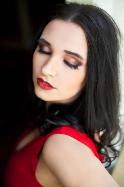 Young beautiful woman in red dress — Stock Photo, Image