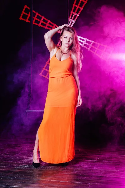 Young beautiful woman in orange dress — Stock Photo, Image