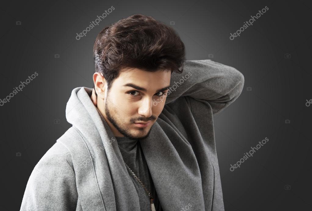Young handsome bearded caucasian man posing indoors. Perfect skin and  hairstyle. Wearing elegant jacket, jeans. Studio portrait with dramatic  light. Stock Photo | Adobe Stock