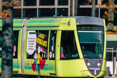 Fransa 'yı 14 Kasım 2020' de Reims şehrinin sokaklarında ve toplu taşıma sisteminde seyahat eden yolcular için modern bir elektrikli tramvaya bakıyor.
