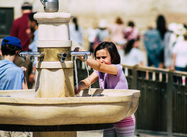 Jerusalem Israel July 2, 2019 View of unknown Israeli people drinking to the fountain located at the Western wall in the Old city of Jerusalem in the afternoon