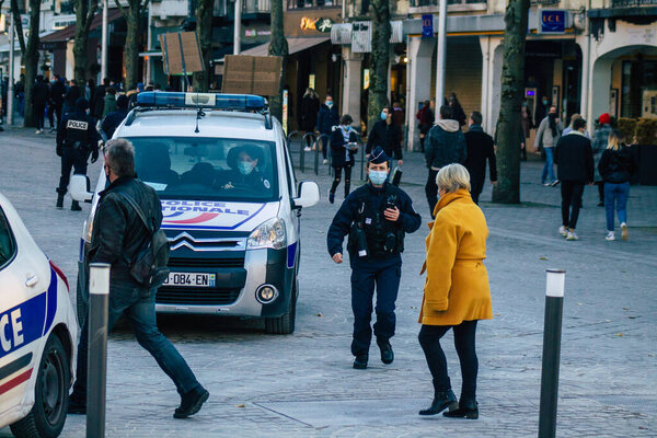 Reims France November 28, 2020 View of French police officer patrolling in the historical streets of Reims during coronavirus pandemic and the lockdown to impose containment of the population