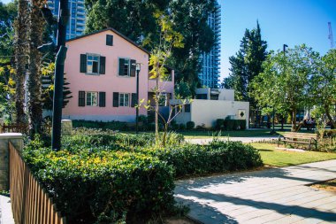 Tel Aviv İsrail 28 Aralık 2020 Sarona Mahallesi, eski bir yerleşim yeri, bir Alman Protestan topluluğu ve Ganei Sarona, gökdelenlerin arka planına karşı korunmuş evleri olan bir park