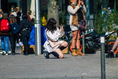 Fransa 'yı 1 Nisan 2021' de Coronavirus salgını sırasında Reims sokaklarında yürüyen ve Fransa 'yı etkileyen koronavirüsten kendilerini korumak için maske takmış yayalar.