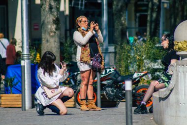 Fransa 'yı 1 Nisan 2021' de Coronavirus salgını sırasında Reims sokaklarında yürüyen ve Fransa 'yı etkileyen koronavirüsten kendilerini korumak için maske takmış yayalar.