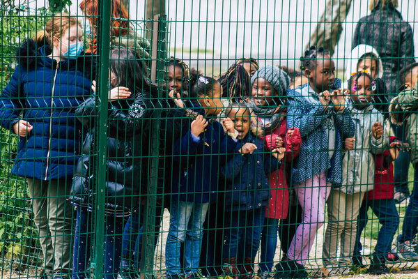 Reims France May 04, 2021 Kids at the elementary school excited to see French fire fighter in intervention in the streets of Reims during the coronavirus outbreak hitting France