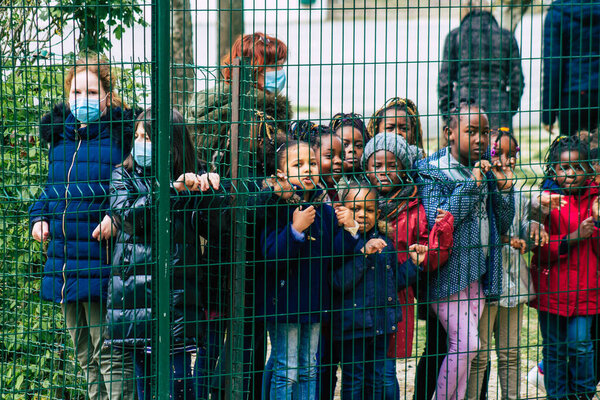 Reims France May 04, 2021 Kids at the elementary school excited to see French fire fighter in intervention in the streets of Reims during the coronavirus outbreak hitting France