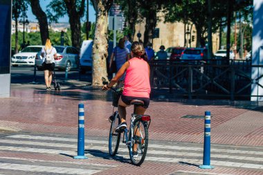 Seville Spain July 09, 2021 People rolling with bicycle in the streets of Seville, an emblematic city and the capital of the region of Andalusia, in the south of Spain