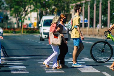 Seville Spain July 09, 2021 Pedestrians walking in the streets of Seville during the coronavirus outbreak hitting Spain, wearing a mask in the street is not mandatory