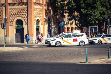 Seville, İspanya, 4 Ekim 2025. Taksi Sevilla 'nın tarihi şehir merkezinden geçiyor. Dar, pitoresk sokaklardan geçiyor..