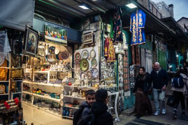 Kudüs, İsrail, 13 Aralık 2025 Kudüs 'ün Hristiyan Mahallesi' ndeki dar sokaklar ve atmosferik ışık oyunları yerel satıcılar tarafından sergilenen çeşitli ürünlere bir göz atma olanağı sağlıyor..