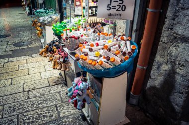 Kudüs, İsrail, 13 Aralık 2025 Kudüs 'ün Hristiyan Mahallesi' ndeki dar sokaklar ve atmosferik ışık oyunları yerel satıcılar tarafından sergilenen çeşitli ürünlere bir göz atma olanağı sağlıyor..