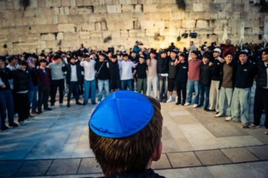 Kudüs, İsrail, 14 Aralık 2025 Yahudi gençler Eski Kudüs 'teki Hanuka kutlamaları sırasında Batı Duvarı (Kotel) önünde sevinçle omuz omuza ve dans ediyorlar..