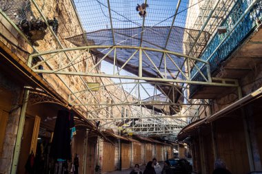 Hebron, Batı Şeria, 17 Aralık 2025 Eski Şehirdeki Filistin sokaklarına kurulmuş koruyucu metal ağlar İsrailli yerleşimcilerin yukarıdaki evlerden attığı taş ve enkazı yakalamak için.