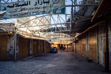 Hebron, Batı Şeria, 17 Aralık 2025 Eski Şehirdeki Filistin sokaklarına kurulmuş koruyucu metal ağlar İsrailli yerleşimcilerin yukarıdaki evlerden attığı taş ve enkazı yakalamak için.