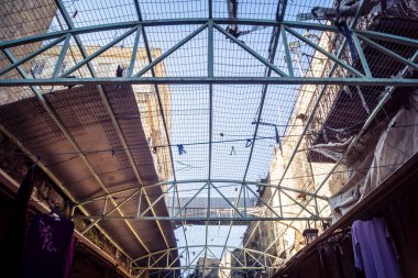 Hebron, Batı Şeria, 17 Aralık 2025 Eski Şehirdeki Filistin sokaklarına kurulmuş koruyucu metal ağlar İsrailli yerleşimcilerin yukarıdaki evlerden attığı taş ve enkazı yakalamak için.