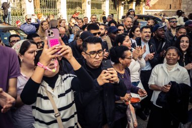 Beytüllahim, Batı Şeria, 25 Aralık 2025. İsa 'ya tapanların yakın çekimleri, İsa' nın Doğumu Kilisesi 'nin önünde rahipler tarafından verilen açık hava konserinde kendilerini adamış bir şekilde şarkı söylemeleri..