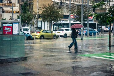 Tel Aviv, İsrail, 29 Aralık 2025. Yayalar şemsiyelerle yağmurda yürür Orta Doğu 'nun en modern şehirlerinden biri olan Tel Aviv sokaklarında..