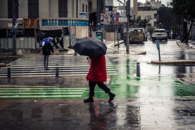 Tel Aviv, İsrail, 29 Aralık 2025. Yayalar şemsiyelerle yağmurda yürür Orta Doğu 'nun en modern şehirlerinden biri olan Tel Aviv sokaklarında..