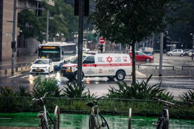 Tel Aviv, İsrail, 29 Aralık 2025. Magen David Adom (MDA) ambulansı Tel Aviv, İsrail sokaklarında acil durum ışıklarıyla yol alıyor. Kentsel acil servis sahnesi.