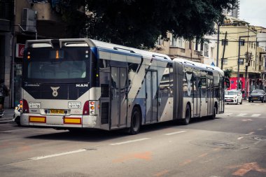 Tel Aviv, İsrail, 19 Ocak 2026. Otobus Florentin Mahallesi boyunca yol alıyor. Şehir hareketliliğini ve akışını sürdüren modern şehir yaşam tarzını yansıtan canlı bir merkez cadde..