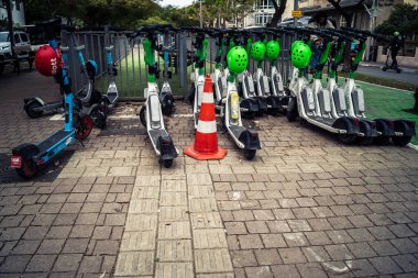 Tel Aviv, İsrail, 21 Ocak 2026 Rothschild Bulvarı boyunca elektrikli scooterlar park etti. Tel Aviv 'de ağaçlarla kaplı, canlı bir merkez cadde. Modern şehir yaşam tarzını yansıtıyor..