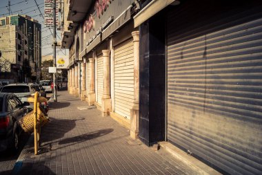 Hebron, Batı Şeria, 30 Ocak 2026 kapalı dükkan kepenkleri ve Hebron şehrinin caddesinde çift taraflı metal kapılar. Cuma günkü ticari kapanma sembolleri.