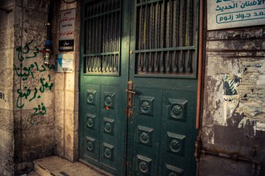 Hebron, Batı Şeria, 30 Ocak 2026 kapalı dükkan kepenkleri ve Hebron şehrinin caddesinde çift taraflı metal kapılar. Cuma günkü ticari kapanma sembolleri.