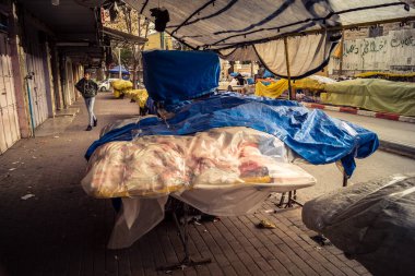 Hebron, Batı Şeria, 30 Ocak 2026. El Halil 'in merkezindeki haftalık kapanış sırasında plastik muşamba kaplı sokak satıcısı ve market tezgahları..