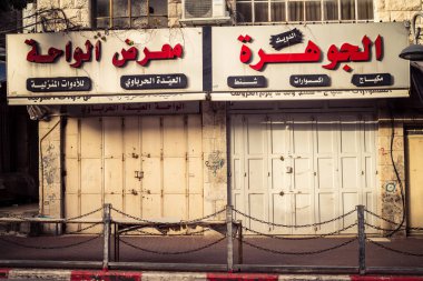 Hebron, Batı Şeria, 30 Ocak 2026 kapalı dükkan kepenkleri ve Hebron şehrinin caddesinde çift taraflı metal kapılar. Cuma günkü ticari kapanma sembolleri.