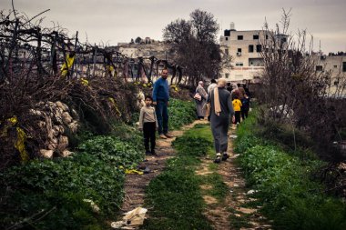 Beit Einun, Batı Şeria, 9 Şubat 2026. Ana yol kapandığı için köy sakinleri toprak bir yan yoldan geçerek köylerine giriyor. İsrail ordusunun kontrolü altındaki günlük mücadele sahnesi.