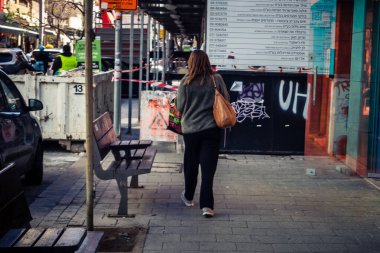 Tel Aviv, İsrail, 26 Şubat 2026, Sheinkin Caddesi 'nde yürüyen yayalar, dinamik hareketli canlı şehir manzarası, arkaplan olarak Bauhaus mimarisi, canlı şehir yaşamı, çeşitli sokak dokularında güneş ışığı, ritmik geometri ve çağlayan ışık obse