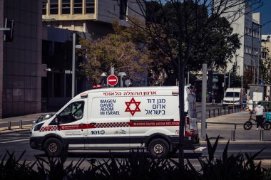 Tel Aviv, İsrail, 6 Mart 2026 Magen David Adom (MDA) ambulansı Tel Aviv, İsrail sokaklarında acil durum ışıklarıyla yol alıyor. Kentsel acil servis sahnesi.