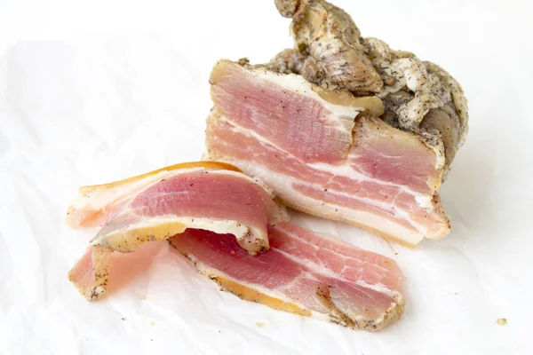 Salty bacon, a piece of paper lying on the — Stock Photo, Image