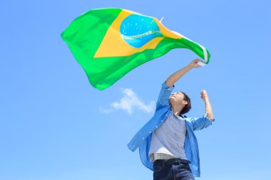 man holding brazilian  flag clipart